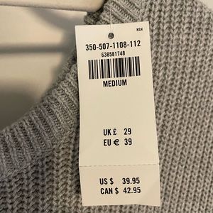 Hollister medium weight gray sweater ties at the bottom on one side.